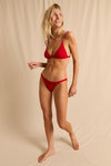 anja triangle bikini top le minimaliste red studio background